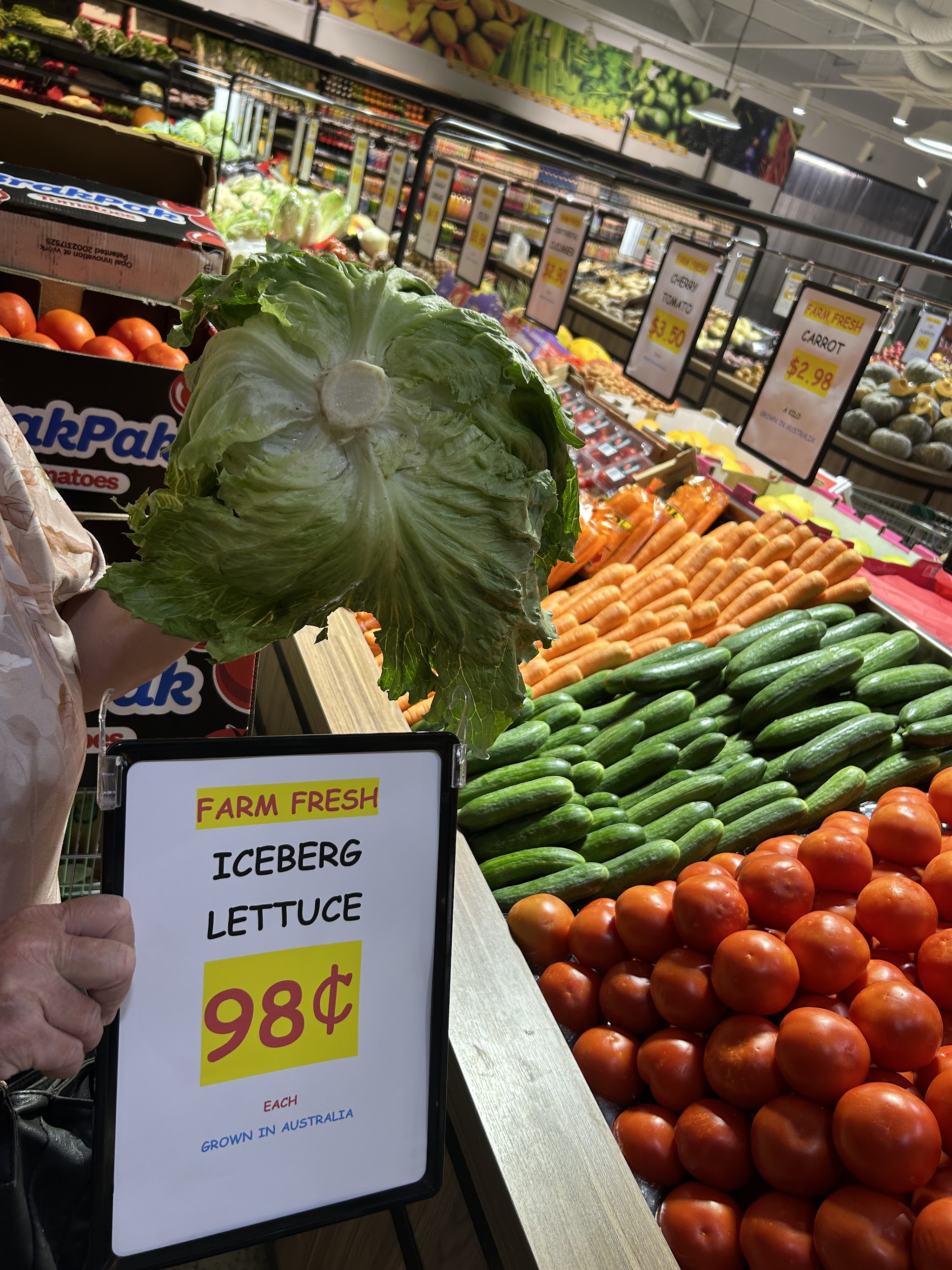 Iceberg lettuce beside a Farm Fresh, Grown in Australia sign